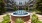 a fountain in a courtyard with buildings in the background