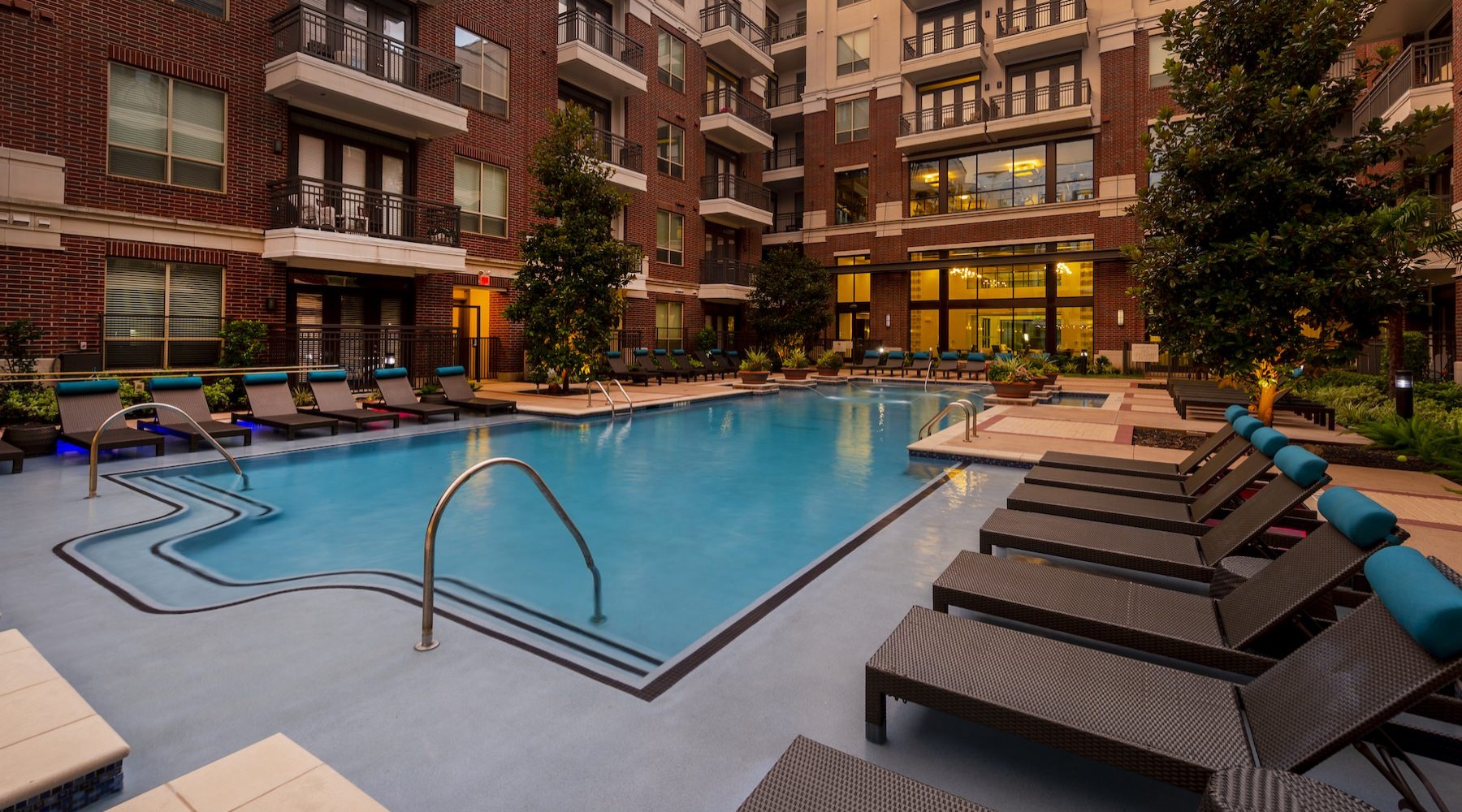 Sparkling blue pool with a large pool deck 