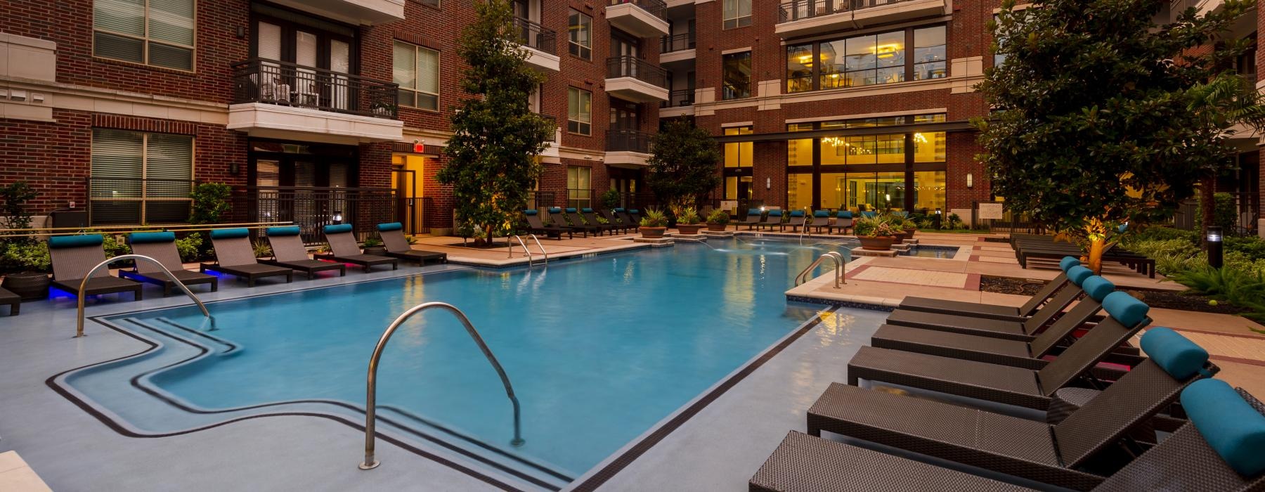 a swimming pool in a courtyard between buildings